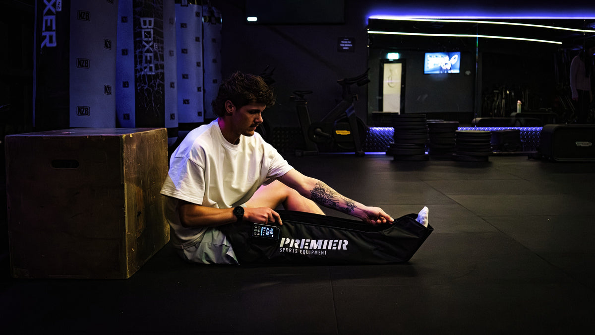 Zipping on an AeroBoots Pro at the gym, the control unit lit